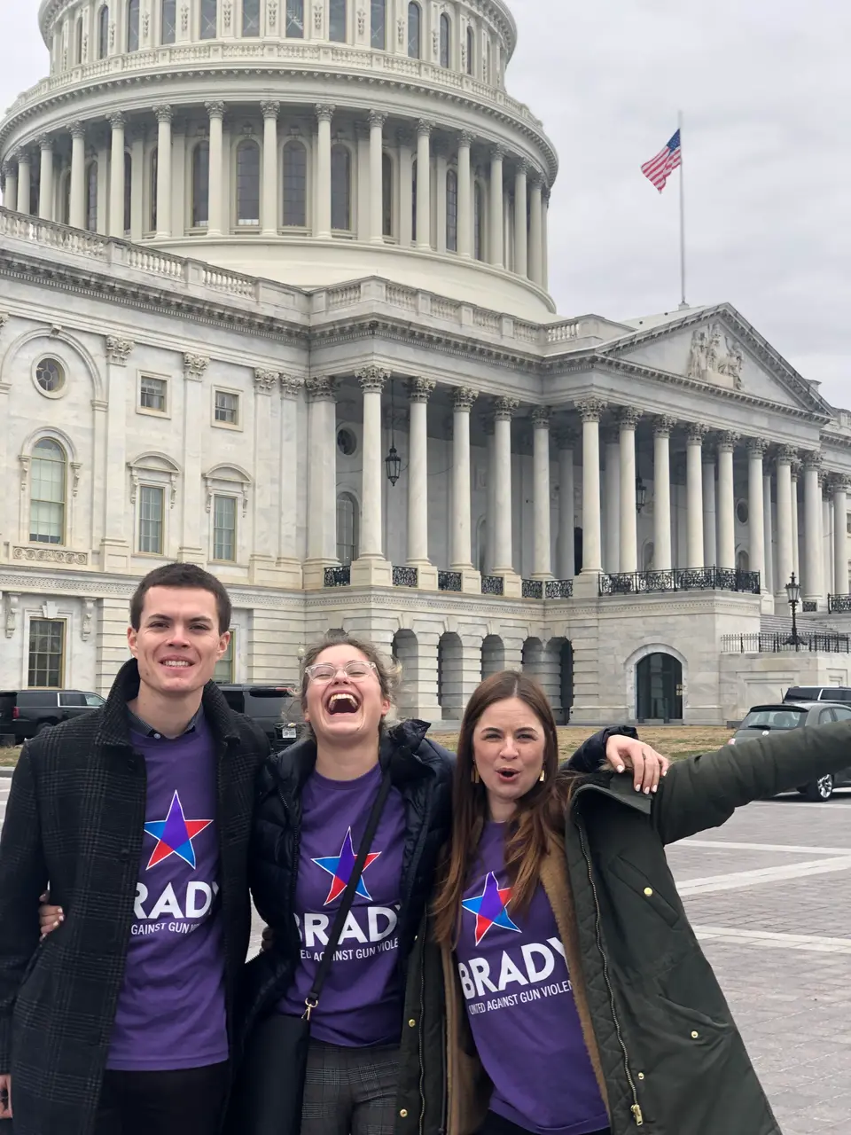 Three Brady employees and activists pose happily outside of the house the last time the background bill passed in 2020