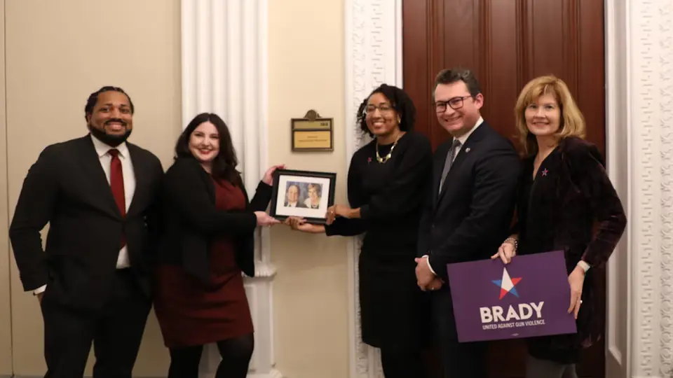 The hosts of RBB and the office of gun violence prevention pose with a photo of jim and sarah brady